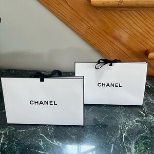 Chanel triangular gift box with white shredded paper.  2 available